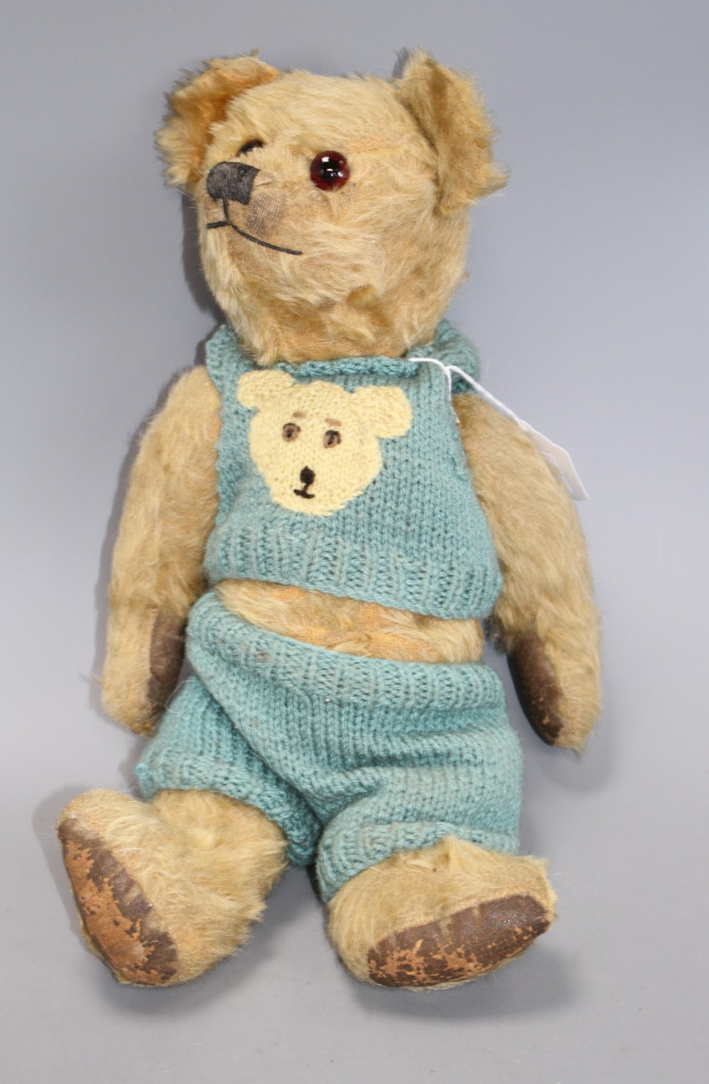 An Omega bear c.1950s, 16in., rexine pads, general hair loss
